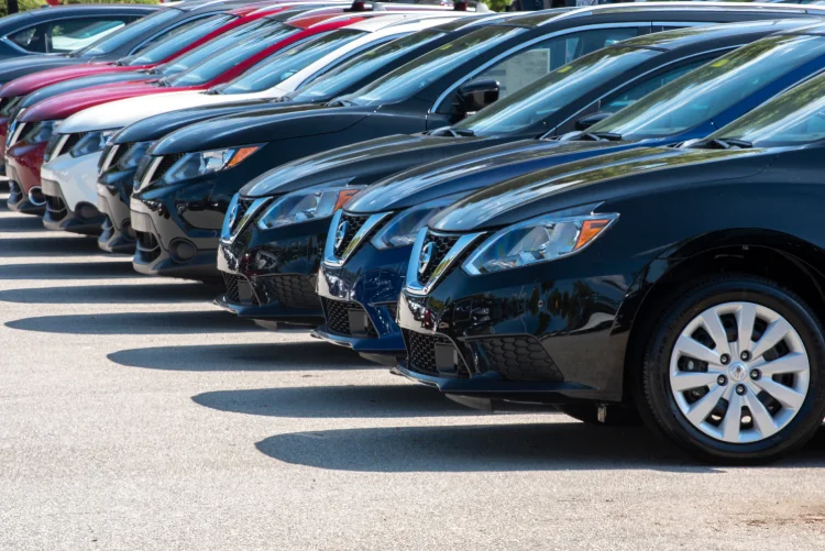 A row of Nissan vehicles at a company owned dealership A row of Nissan vehicles at a company owned dealership.