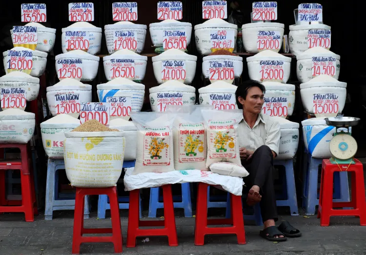 Vietnamese salesman sit at rice store Vietnamese salesman sit at rice store of outdoor farmer market.